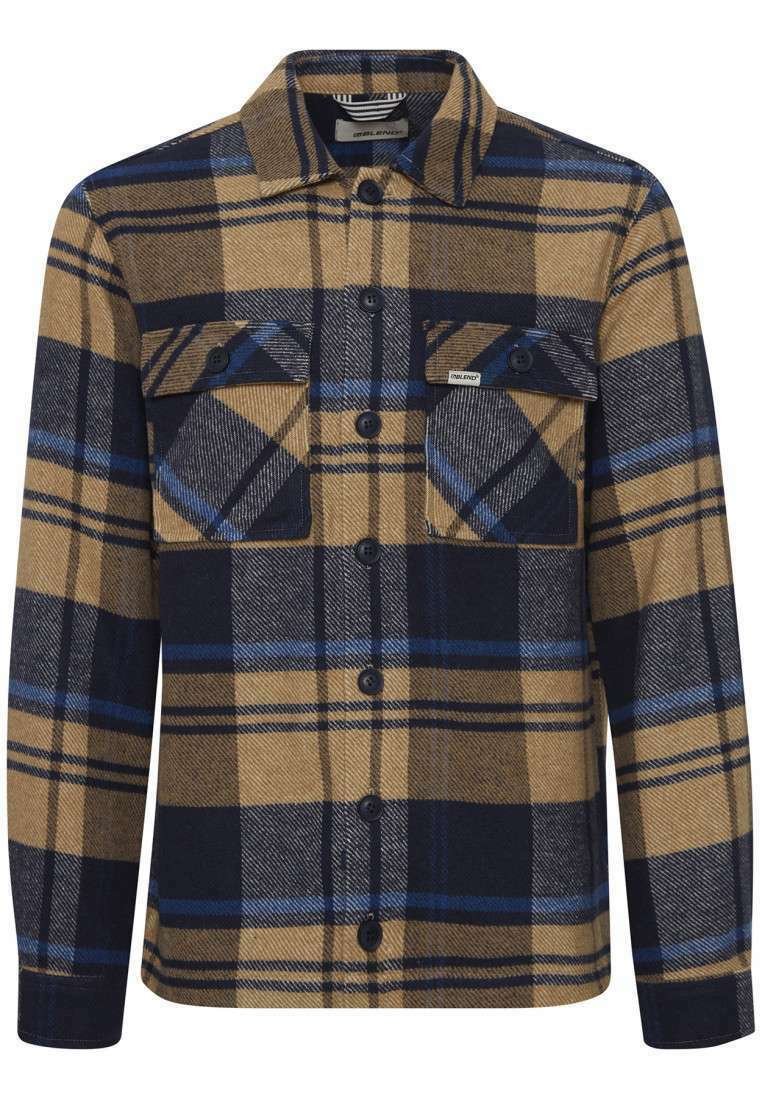 Camicia di flanella a quadri nei toni del marrone, blu navy e azzurro. Presenta due tasche sul petto, chiusura con bottoni e maniche lunghe con polsini abbottonati.