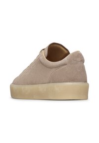 Sneaker beige in suede con profilo basso, forma arrotondata e suola in gomma texturizzata. Design minimalista e dettagli di cucitura sottili.