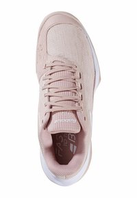 Chaussure de sport rose clair avec une tige en mesh texturé, des lacets plats et des accents blancs. La semelle intérieure affiche un logo de marque.
