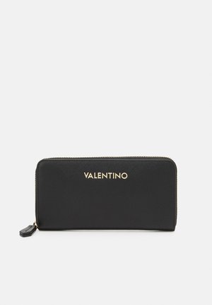 Black zip-around wallet in textured material, features gold "VALENTINO" logo, rectangular shape with smooth edges, and a small hardware accent.