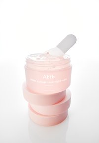Barattolo rosa traslucido con coperchio bianco, contenente una sostanza gelatinosa e un applicatore bianco. Etichette di testo in bianco indicano i dettagli del prodotto.