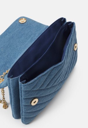 Blue quilted fabric handbag with gold snap buttons and chain strap, shown open to reveal two inside compartments with dark blue lining.