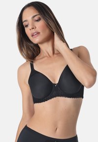 Black lace bra with smooth cups, wide straps, and scalloped edges. Features a small decorative clasp at the center. Soft texture.