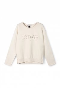 Sweat-shirt beige clair avec col rond, épaules tombantes et poignets côtelés. Présente un logo "10 DAYS" brodé et des accents de texte minimalistes.