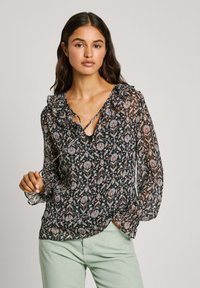 Blusa nera a fiori con scollatura arricciata, maniche lunghe e scollatura a V profonda. Presenta un intricato motivo multicolore su tessuto trasparente.