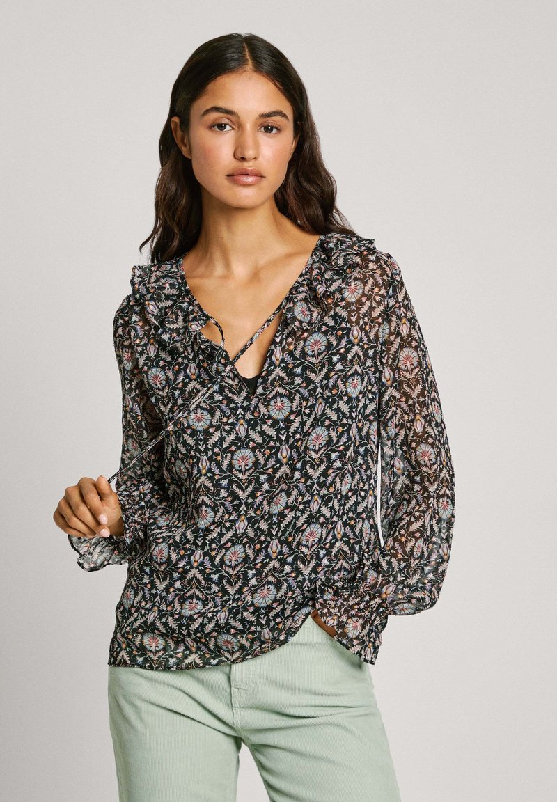 Blusa nera a fiori con scollatura arricciata, maniche lunghe e scollatura a V profonda. Presenta un intricato motivo multicolore su tessuto trasparente.