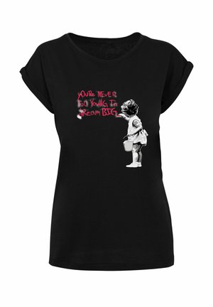 Black T-shirt with graphic of a young girl holding a bucket, painting "You're never too young to dream big" in red and white letters.