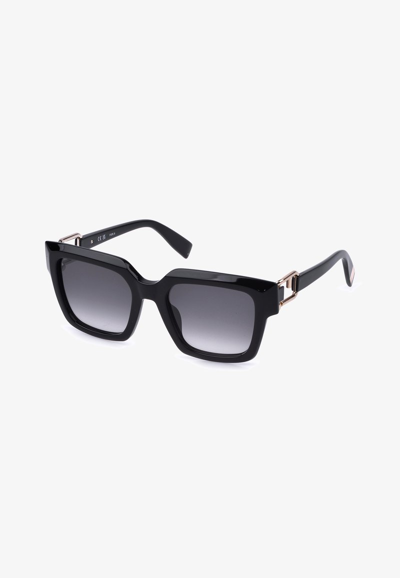 Lunettes de soleil carrées noires oversize avec verres foncés dégradés et fines touches dorées sur les branches, présentées sur fond blanc.