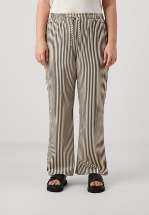 Lightweight, tan striped pants with a relaxed fit. Features an elastic waistband and drawstring, paired with black sandals.