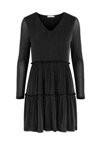 Svart klänning med lång ärm, V-ringning och lager-på-lager kjol. Tillverkad av textil med en subtil glans. Har volangdetaljer vid midjan.
