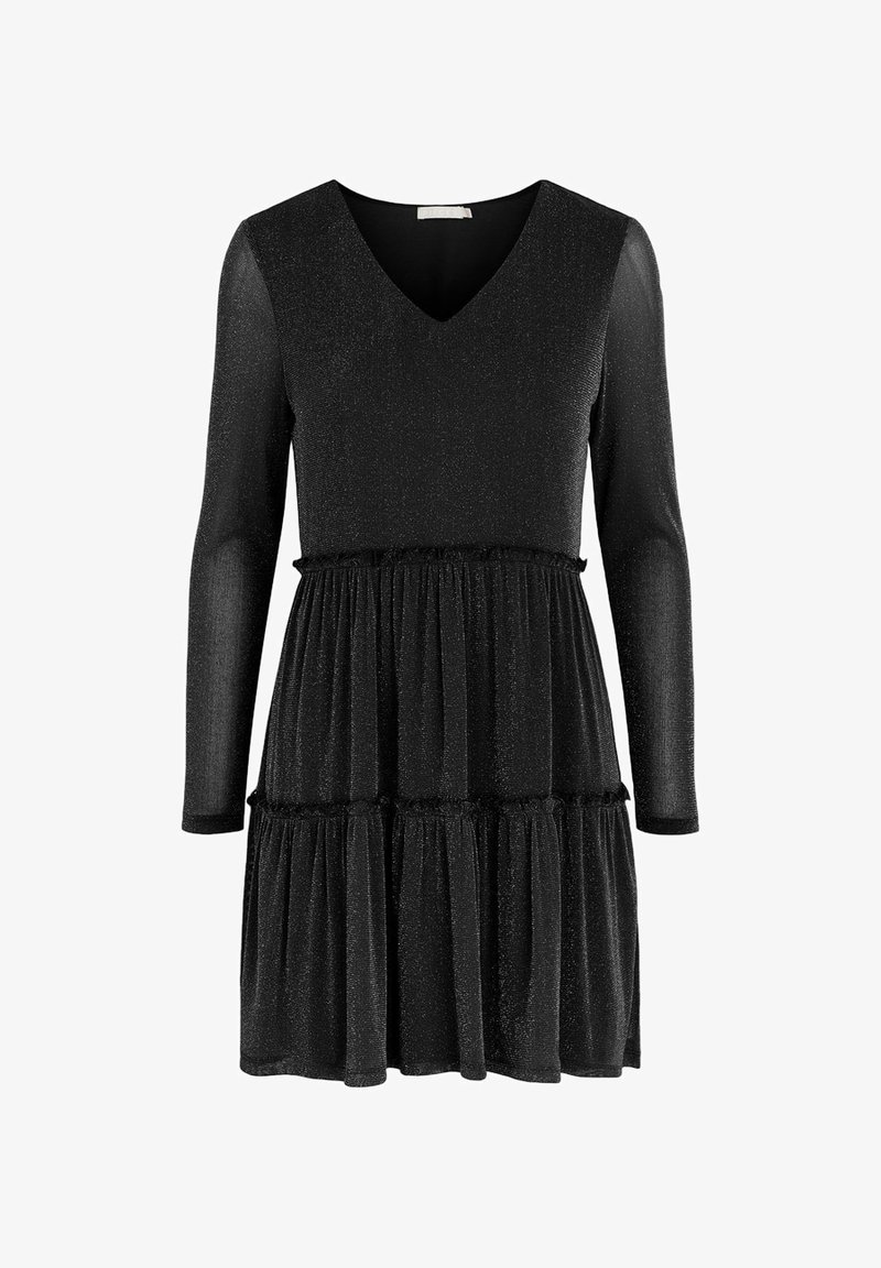 Svart klänning med lång ärm, V-ringning och lager-på-lager kjol. Tillverkad av textil med en subtil glans. Har volangdetaljer vid midjan.