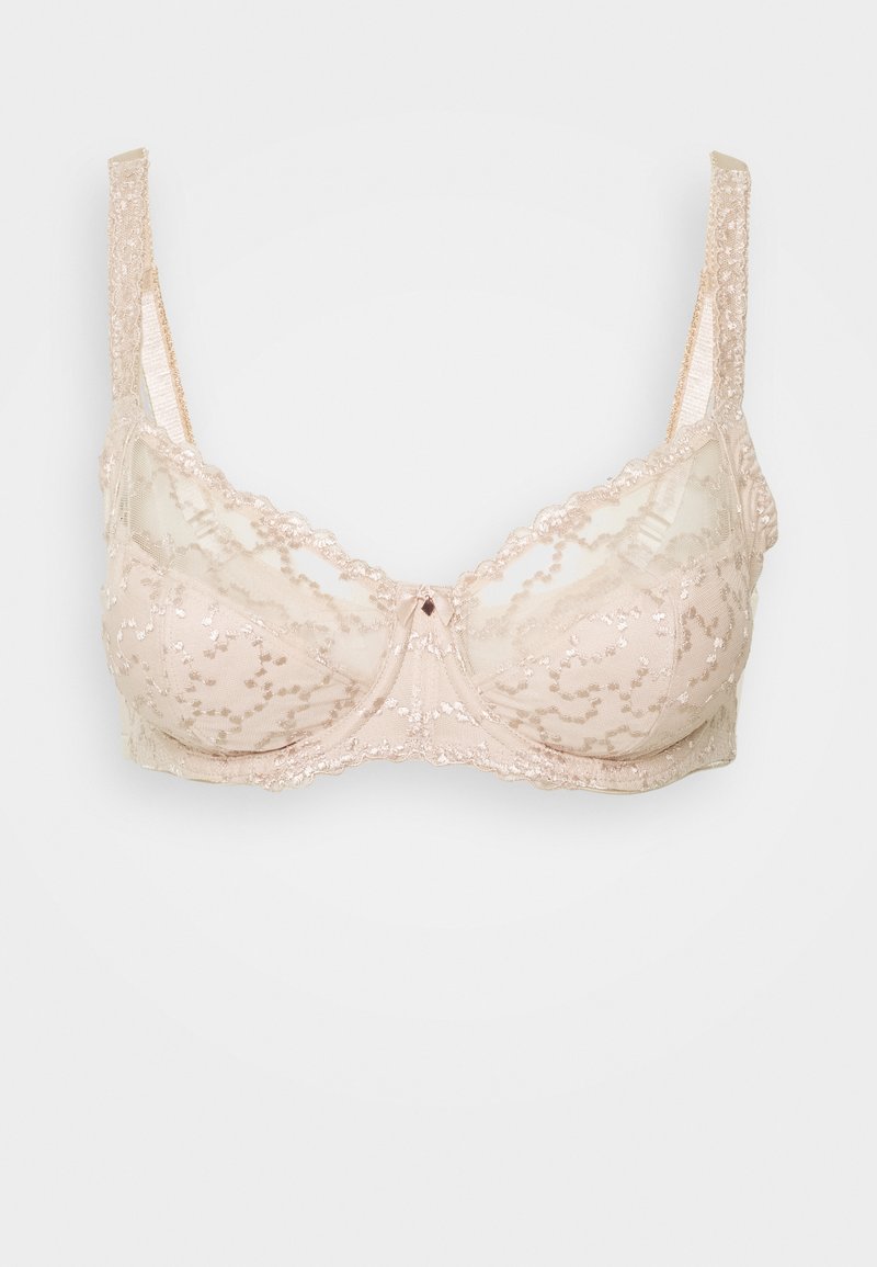 Λεπτό ραντεβού σε μπεζ δαντέλα, διαθέτοντας ημι-διάφανη ύλη, λουλουδάτα σχέδια, κυματιστές άκρες και λεπτές ρυθμιζόμενες τιράντες. Κεντρική λεπτομέρεια με διαμάντι.