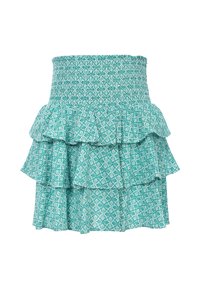Teal gekleurde tiered rok met een smock tailleband, voorzien van een wit loofpatroon op lichte stof. Drie gerimpelde lagen versterken de beweging.