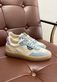 Sneakers in pelle beige e blu con accentuazioni perforate, punta tonda, suola in gomma testurizzata e tab di colore viola a contrasto.