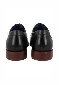 Scarpe in pelle nera con finitura liscia, forma arrotondata e tacchi in legno. Presentano un interno imbottito di colore blu.