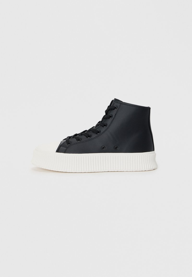 Black high-top sneakers made of smooth material, featuring a white rubber sole with ribbed texture and a classic lace-up closure.