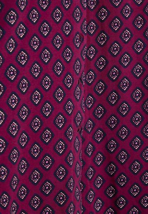 Purple fabric featuring a geometric diamond pattern in navy blue, cream, and light pink, with a soft texture and slight sheen.