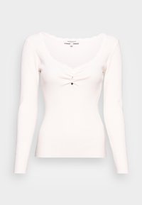 Top bianco a maniche lunghe con costine, caratterizzato da un collo scallop, tre bottoni sul davanti e una silhouette aderente. Texture morbida.