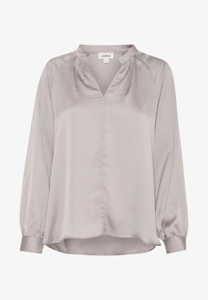 Helles graues Blusenshirt aus glattem Stoff. Mit V-Ausschnitt, gefalteten Schultern und langen Ärmeln mit gerafften Manschetten. Verlängertes Hemd.