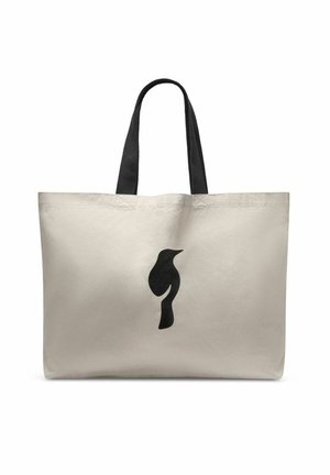 Beżowa torba na ramię ze skóry płóciennej z czarnymi uchwytami i prostą czarną sylwetką ptaka umieszczoną na środku z przodu.