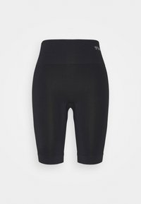 Cuissards de cyclisme noirs sans couture à taille haute avec une large ceinture et un petit logo en haut à gauche, vus de dos.