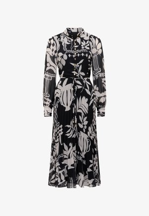 Robe à manches longues à imprimé floral noir et blanc avec un devant boutonné, un col haut, une jupe plissée et une ceinture nouée à la taille.