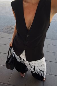 Must mustriga sügav V-avaga, ühe nööbiga sulgemine ja taskud. Peal valge heegeldatud äärisega, millel on narmad, koos lõdva musta pükstest.