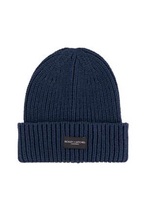 Donkerblauwe gebreide muts met een geribbelde textuur en een omgeslagen boord. Voorzien van een zwart label met de opdruk "BICKLEY + MITCHELL" aan de voorkant.