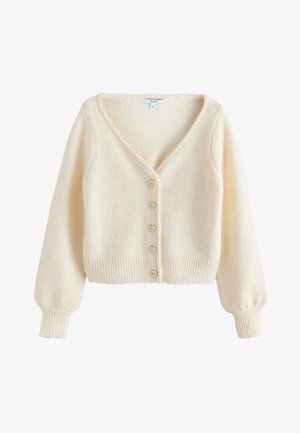 Cardigan pufos de culoare crem, cu mâneci lungi bufante, decolteu în V, tiv și manșete striate, și cinci nasturi în formă de inimă pe față.