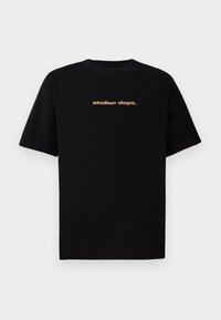 Schwarzes Baumwoll-T-Shirt mit kurzen Ärmeln, das auf der Vorderseite das Logo "atelier dept." in Gold zeigt. Klassisches Rundhalsdesign, lässige Passform.