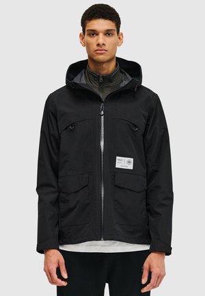 Black waterproof jacket with a zip front, hood, two chest pockets, and a label patch. Features a textured finish and long sleeves.