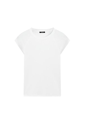 T-shirt blanc à manches courtes en coton doux, avec un col rond et des manches raglan, présentant une coupe droite et décontractée sans motifs.