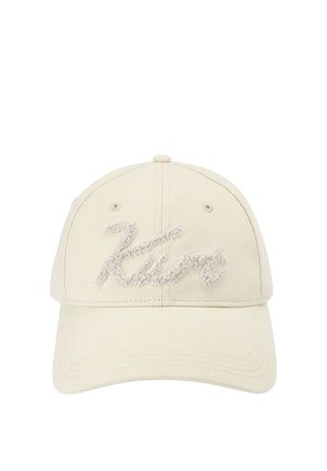 Beżowa czapka z daszkiem z zakrzywionym rondem z teksturowanym haftem w stylu pisma, na którym z przodu widnieje napis "Zara".