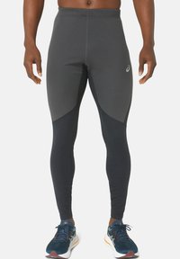 Black athletic leggings with a textured, stretch fabric. Features a contrasting dark grey panel on the sides and a small logo on the hip.