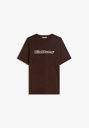 Brown cotton t-shirt featuring a crew neckline and short sleeves. Displayed text in white reads “Rilakkuma.” Smooth texture, casual fit.