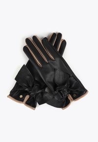 Black leather gloves featuring beige accents, a bow detail at the wrist, and a smooth texture with a snug fit.