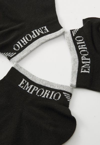 Black cotton socks with white "EMPORIO" logo. Ribbed cuffs feature contrasting gray and white patterns. Soft texture, ankle length design.