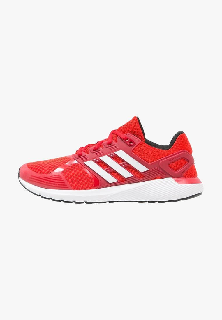 Red athletic shoe with a breathable mesh upper, white three-stripe design, black accents, and textured rubber outsole for grip.