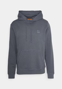 Sudadera gris con capucha, bolsillo frontal y cordones. Presenta un parche de logo cuadrado y acentos naranjas en contraste en el interior de la capucha.