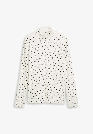 Camicia a maniche lunghe in tessuto bianco con pois neri, caratterizzata da un colletto alto e arricciato e un taglio dritto. Tessuto morbido e leggero.