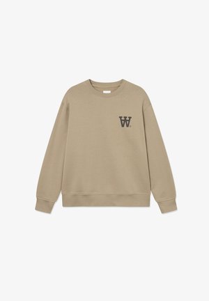 Bēģa sporta krekls ar apaļu kakla izgriezumu, garām piedurknēm un nelielu tumšu logo kreisajā krūtīs. Izgatavots no mīkstas, teksturētas auduma.