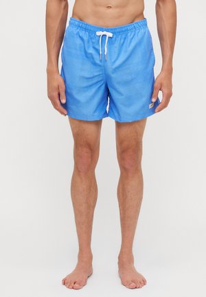 Blue swim trunks with a smooth, lightweight fabric. Features an elastic waistband with a white drawstring and subtle graphic patterns.