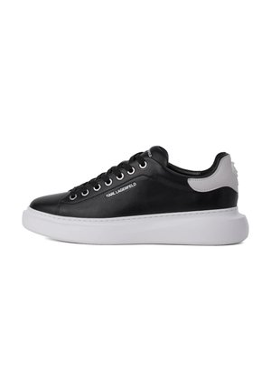 Black low-top sneaker with white sole, white heel detail, black laces, and "KARL LAGERFELD" branding on side.
