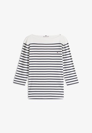 Biela košeľa s dlhým rukávom s horizontálnymi námorníckymi pásmi. Má široký výstrih a malé logo na ľavej strane hrudníka. Jemná textúra látky.