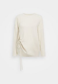 Pull couleur crème à manches longues, texture côtelée, avec un cordon de serrage latéral pour un ajustement personnalisable. Col rond simple, coupe décontractée.