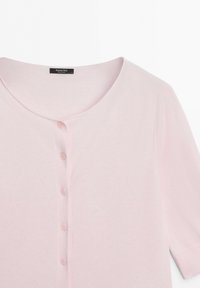 Light pink button-up cardigan with round neckline and short sleeves, showing five buttons and a fabric label inside the collar.