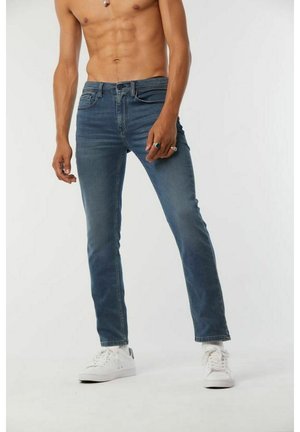 Skinny jeans made of denim, featuring a light blue wash, five pockets, and a front button closure. Textured fabric with slight fading.