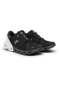 Black running shoes with mesh upper, gray accents, and distinctive lacing. Features cushioned sole and logo on the side.