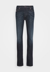 Granatowe dżinsy z denimu, z prostą nogawką, subtelnym przetarciem i kontrastowymi szwami wzdłuż kieszeni i rozporka.