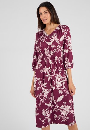 Bloemen midi-jurk in diep bordeaux met crèmekleurige botanische patronen. Heeft een V-hals, driekwart mouwen en een elastische taille.